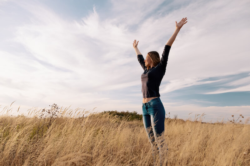 young-happy-woman-golden-field-sunset