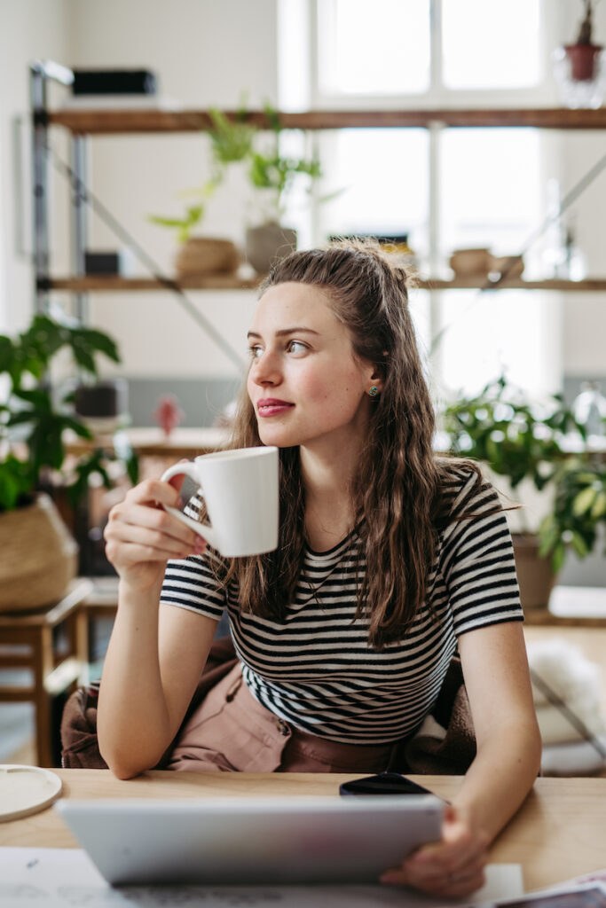 Young woman with adenomyosis drinking coffee