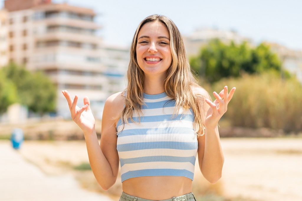 Young pretty woman at outdoors smiling a lot