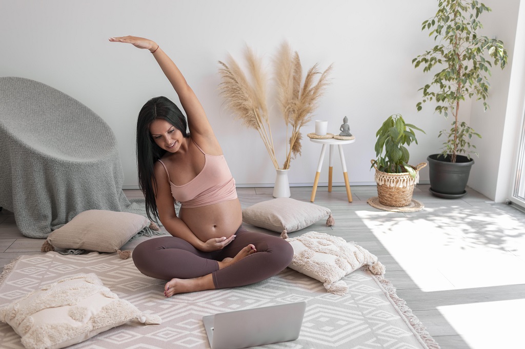 pregnant woman at home doing yoga